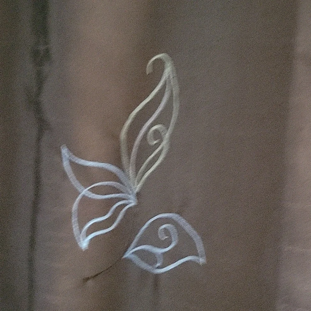 Brown shower curtain with embroidered flowers